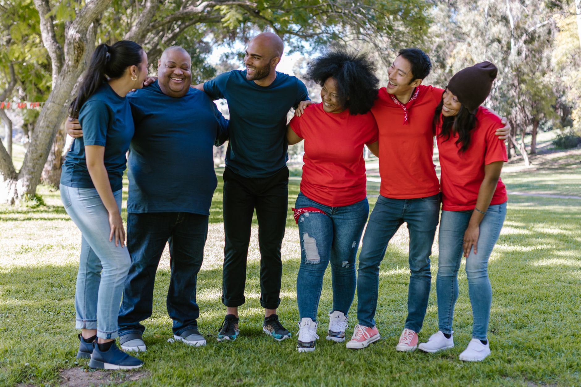 A diverse group of people smiling together outdoors